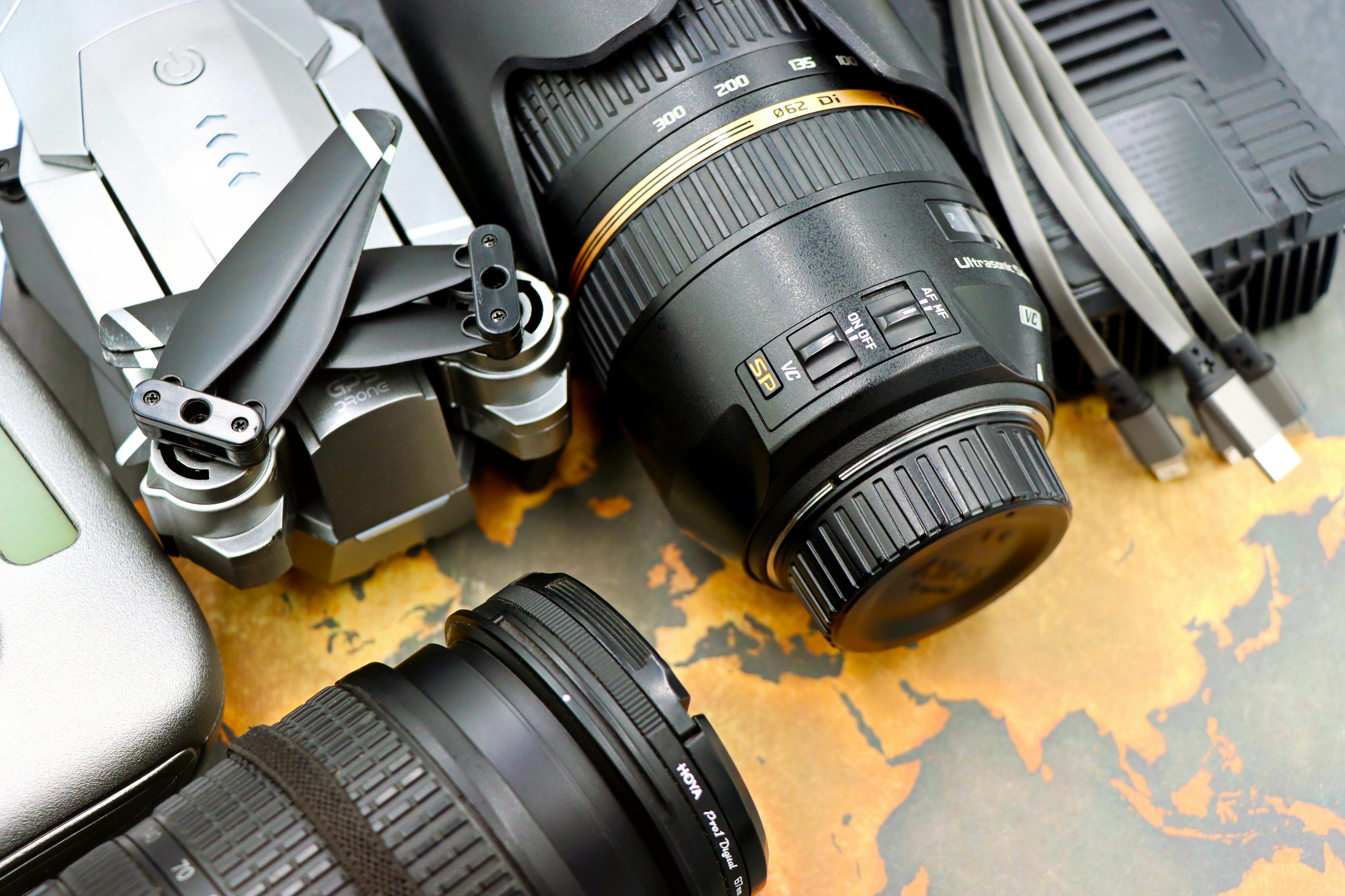 Image of map on table with drone, lenses and cables on top.