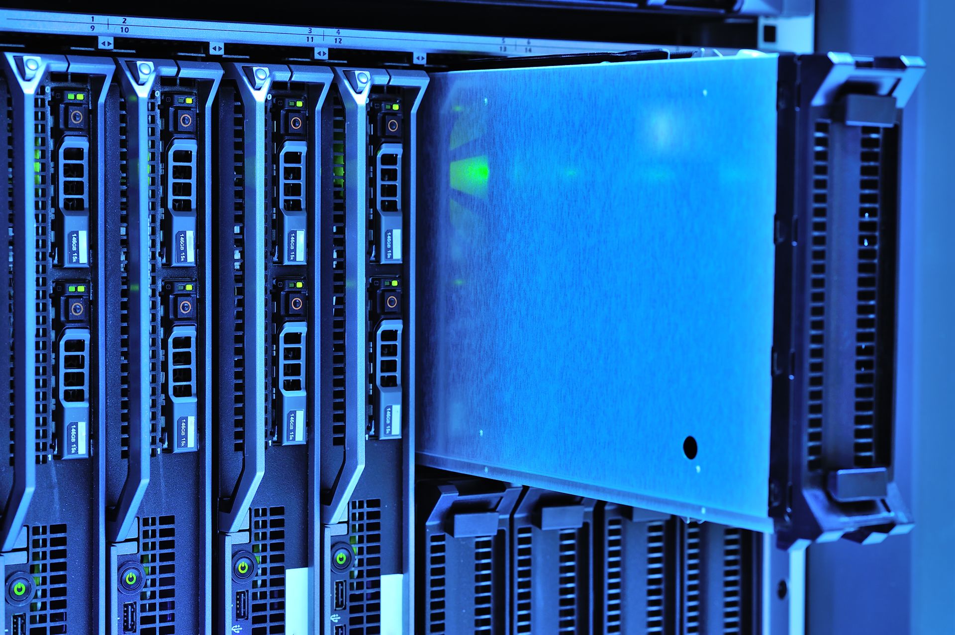 Close up shot of a server rack with one unit being pulled out from the rest.
